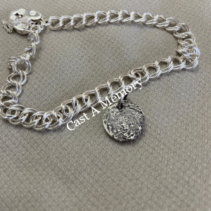 tiny silver charm with fingerprint on bracelet