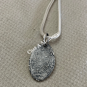 Large oval silver charm with fingerprint on chain