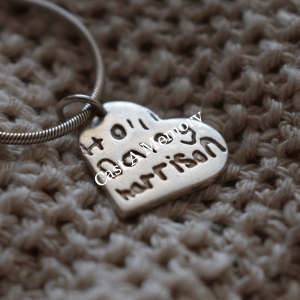 heart shaped silver charm with children names inscribed in