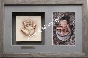 baby clay hand impression with photograph in wooden frame