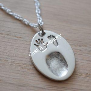 finger print on a silver charm necklace with hand and foot print