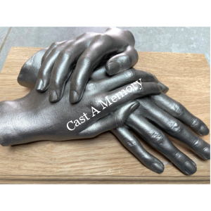 life cast of three hands together on wooden base