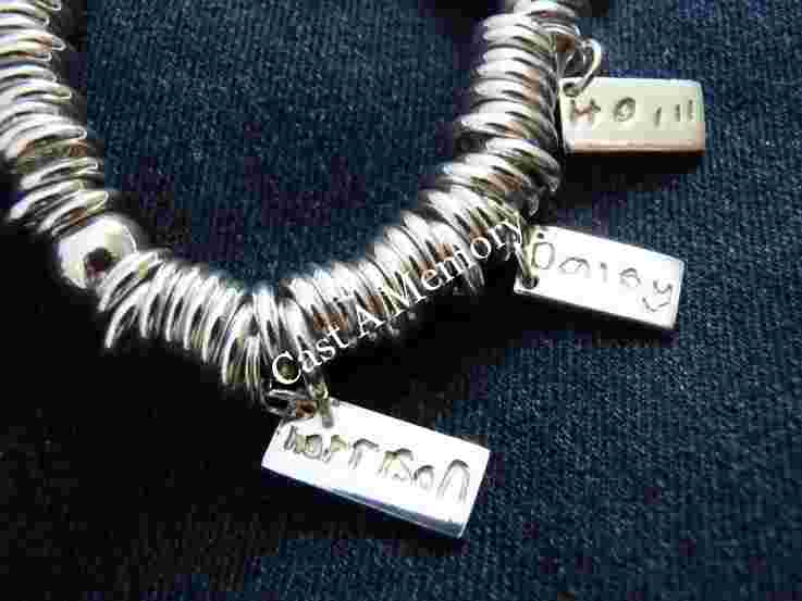 Childs own handwriting on silver charm