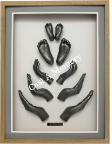 three sets of hands and two feet family life casts framed